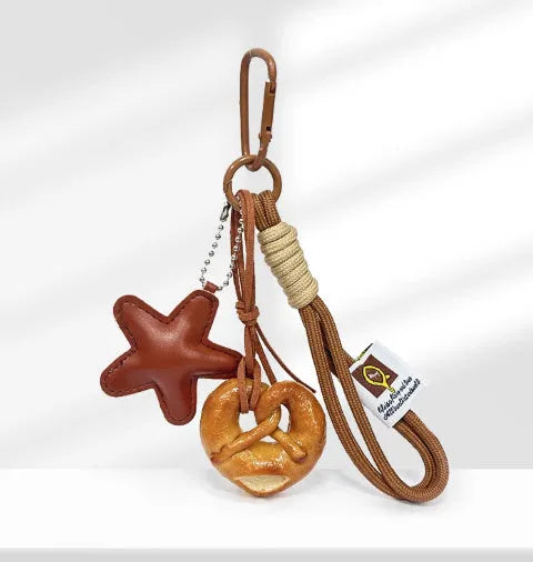Handmade soda bread design handbag pendant with brown star carrying strap and baking varnish finish