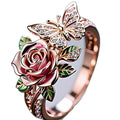 Adjustable butterfly personality ring with colourful oil treatment showing flower, insect and leaf elements
