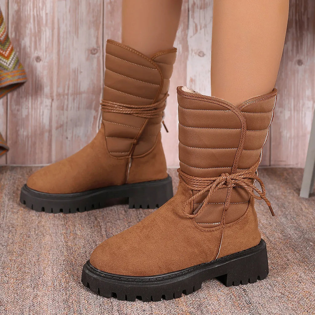 Women's chunky heel mid-calf snow boot with lace-up front and fleece lining in black, brown, or grey.