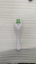 Black handle microneedle roller with purple wheel showing 540 needles, next to white and blue handle options.
