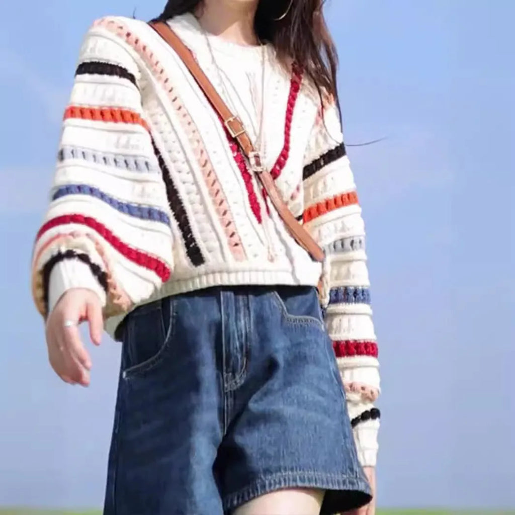 Women's rainbow striped batwing sleeve pullover sweater with a loose fit and round neck.