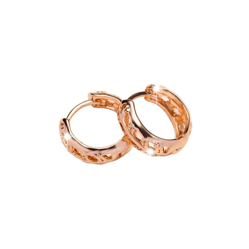 Hollowed-out copper earrings in heart and leaf shapes with a rose gold finish.