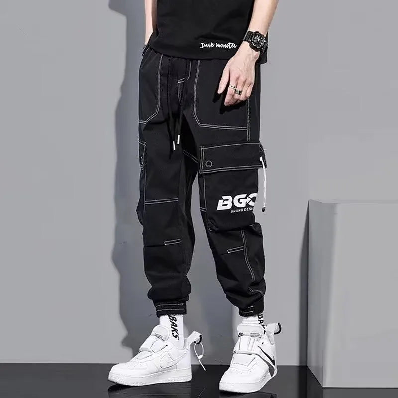 Men's loose fit solid colour polyester trousers in gray, front view, for casual autumn wear