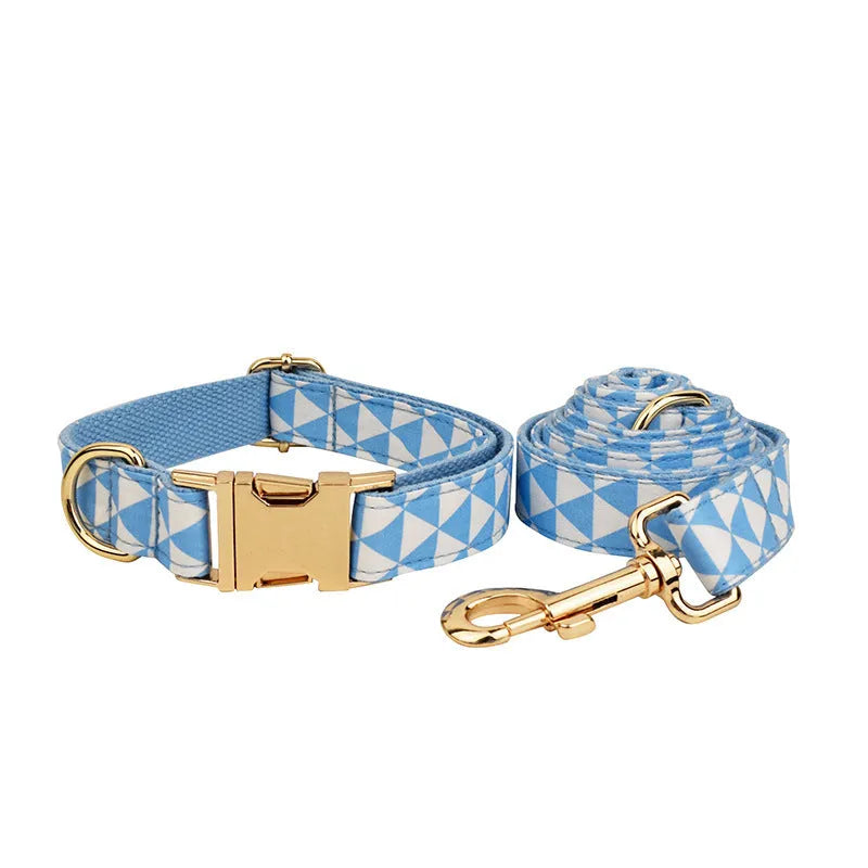 Blue triangular ring pattern dog accessory set with collar, leash, bow, and vest