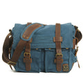 Men's army green canvas crossbody flap bag with leather trim shown open, revealing internal phone and document pockets.