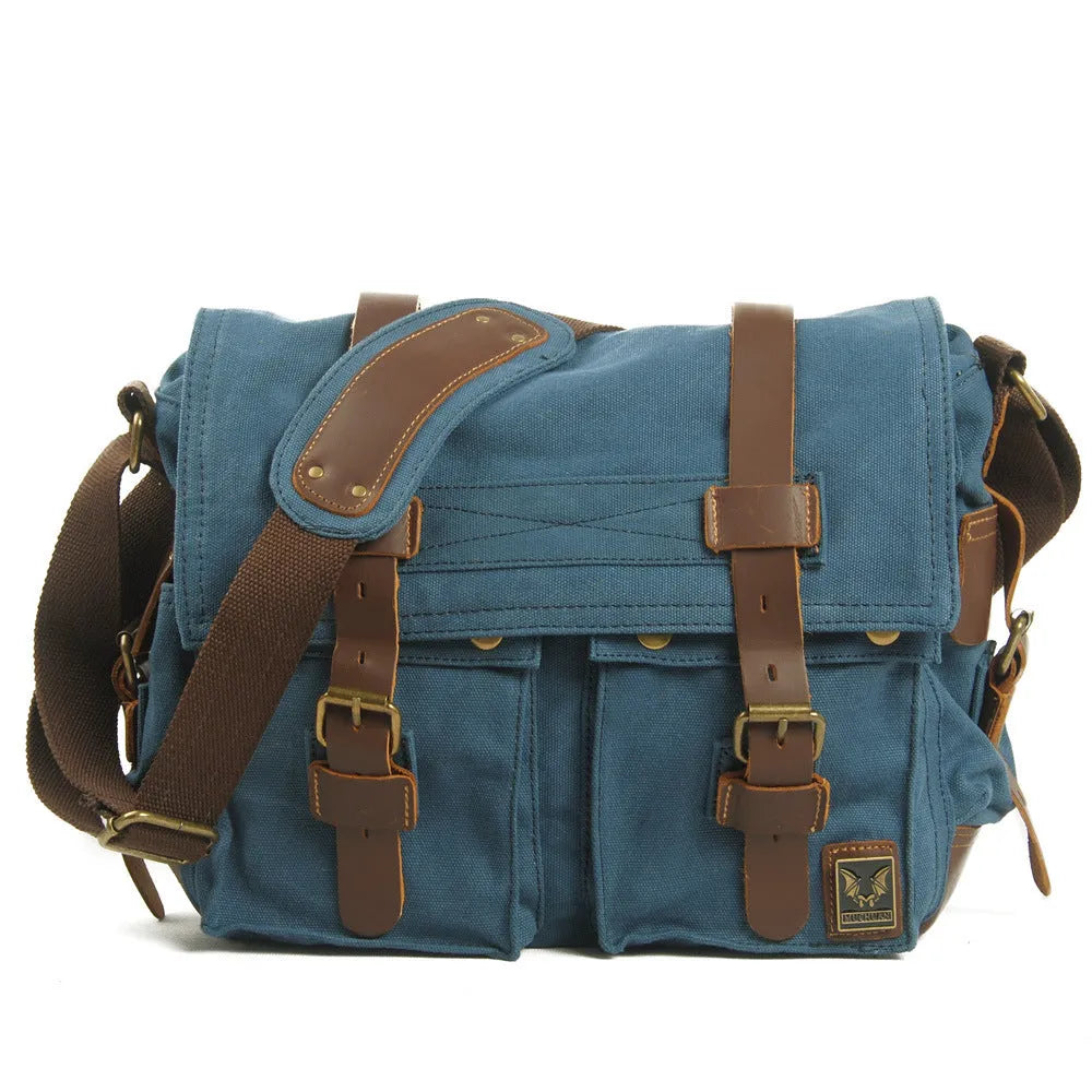 Men's army green canvas crossbody flap bag with leather trim shown open, revealing internal phone and document pockets.