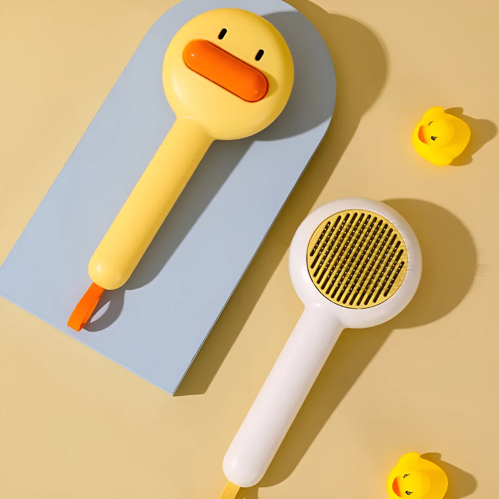 Small yellow duck comb for pet grooming with needle brush construction