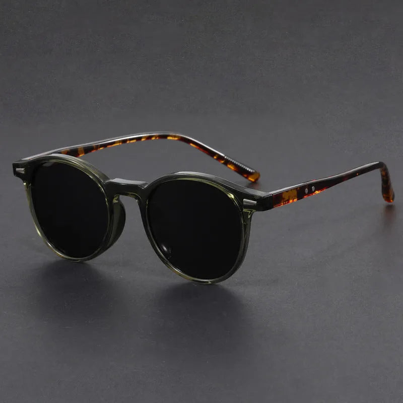 Retro oval frame sunglasses with polarised grey lenses in various frame colours on a light background