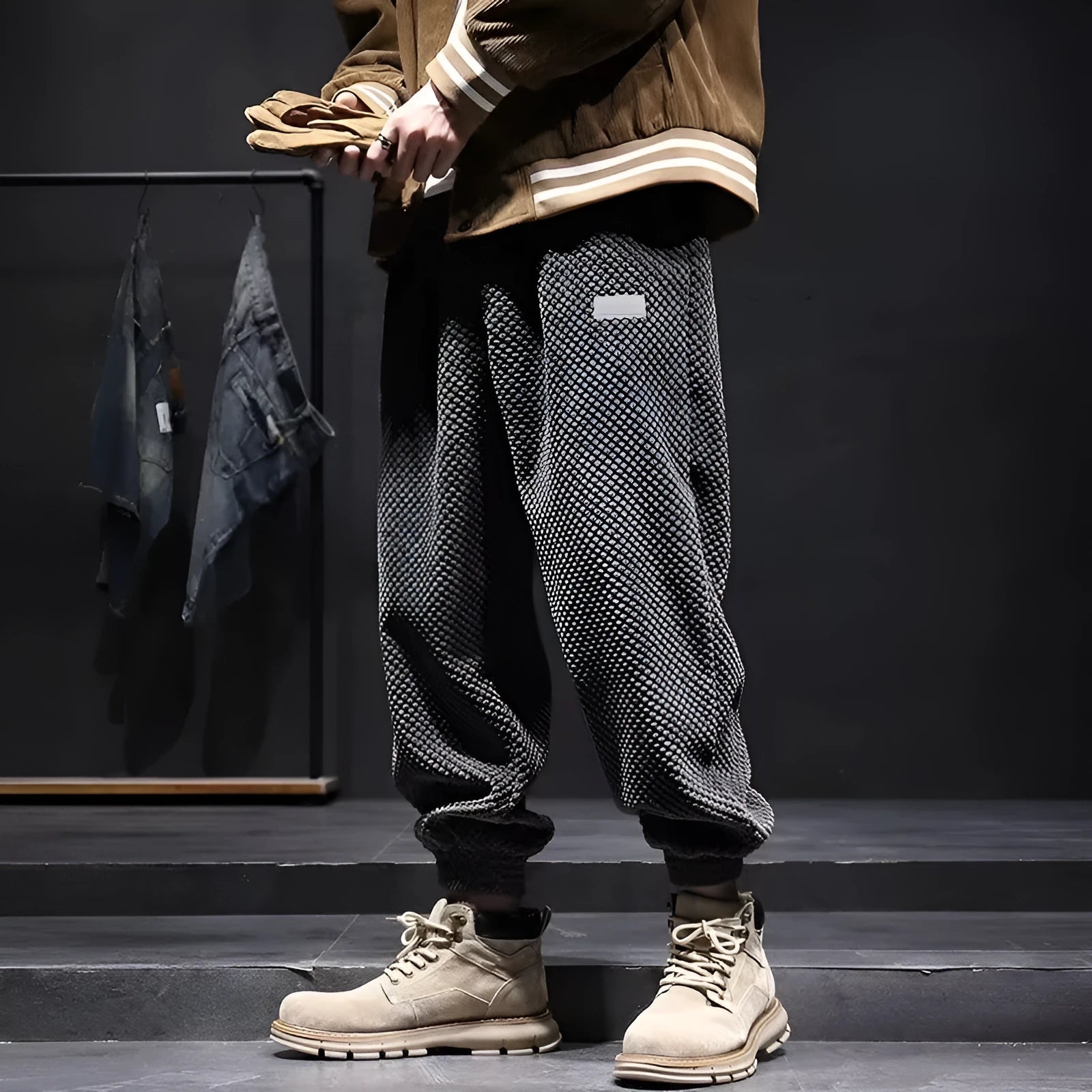 Men's grey ankle-tied straight leg sweatpants laid flat, showing casual sports design.