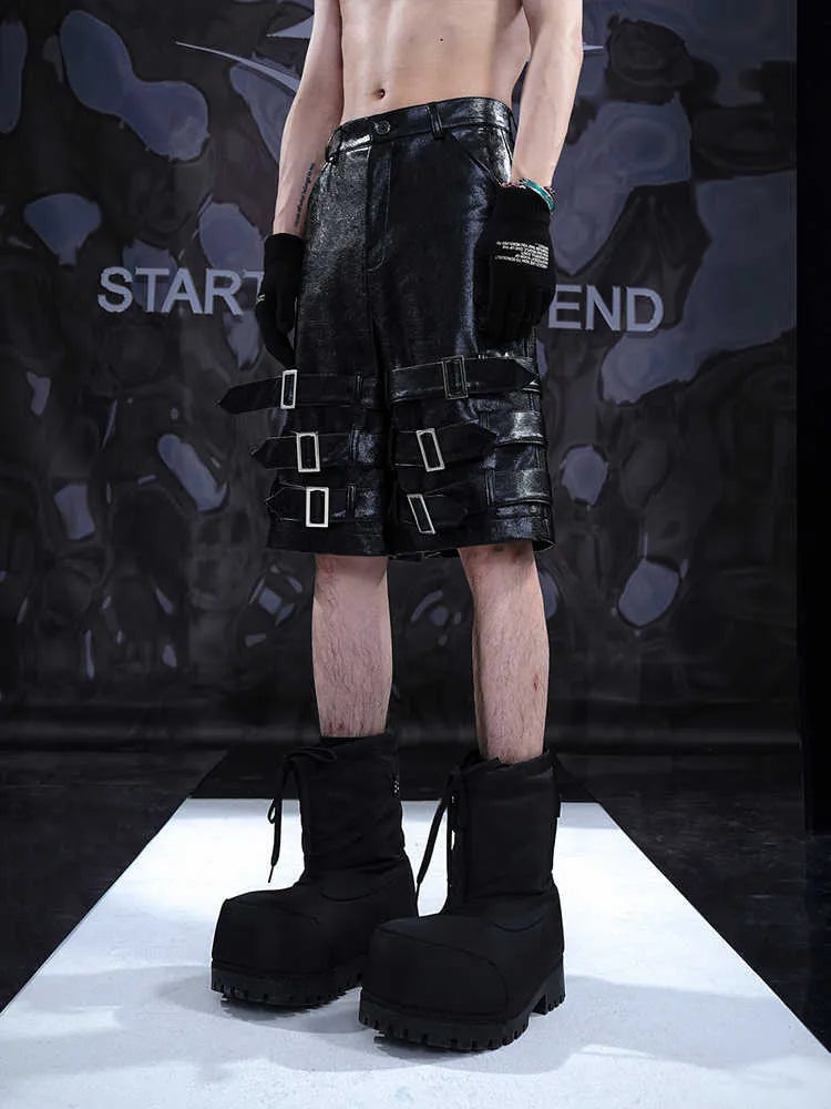 Black men's PU leather cropped shorts on a model, showing medium low waist and casual fit.
