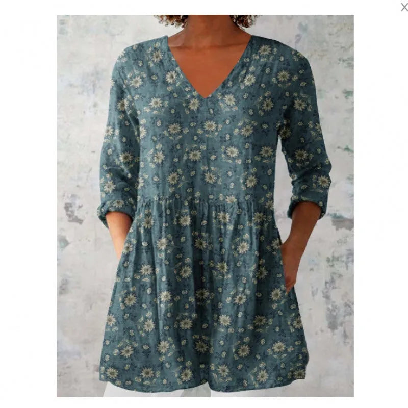 A woman wearing a loose, printed dress with 3/4 sleeves and a wide waist, available in multiple sizes.