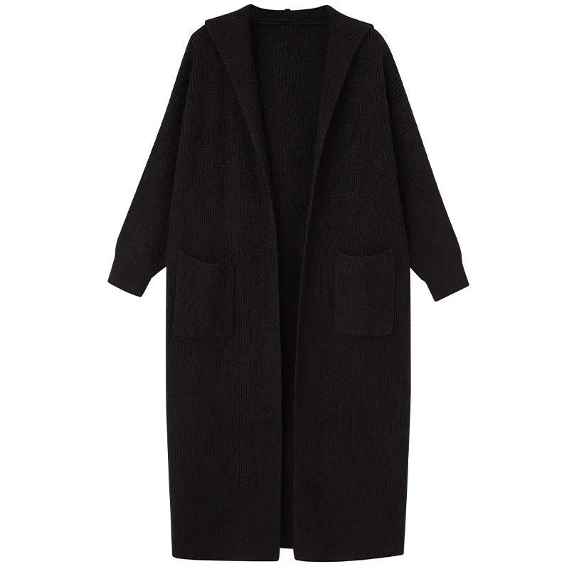 Long grey knitted hooded trench coat worn open as a cardigan.