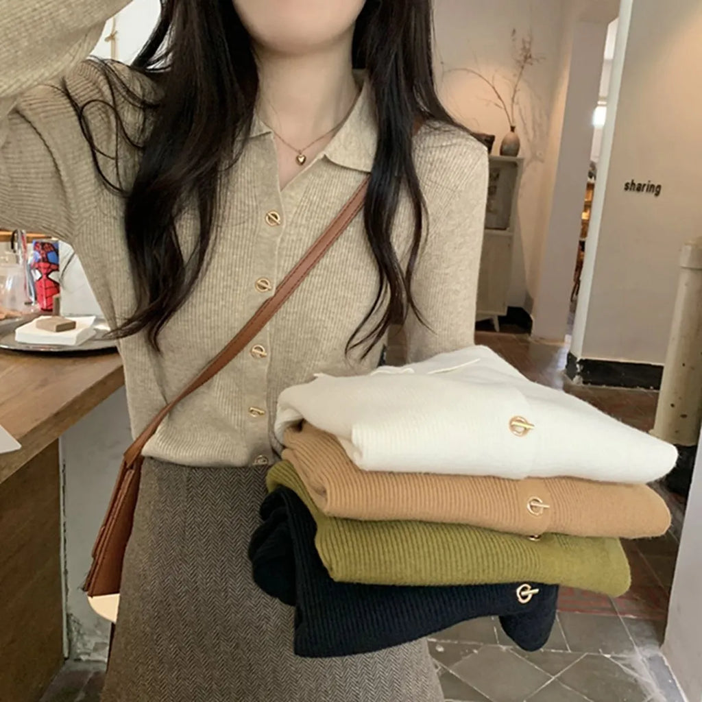 A woman wearing a loose-fit, long-sleeved knitted cardigan in a beige colour, showcasing its drape and cardigan style.