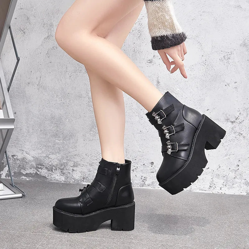 Black women's punk boots with bat buckle, side zip, thick heel, and round toe.