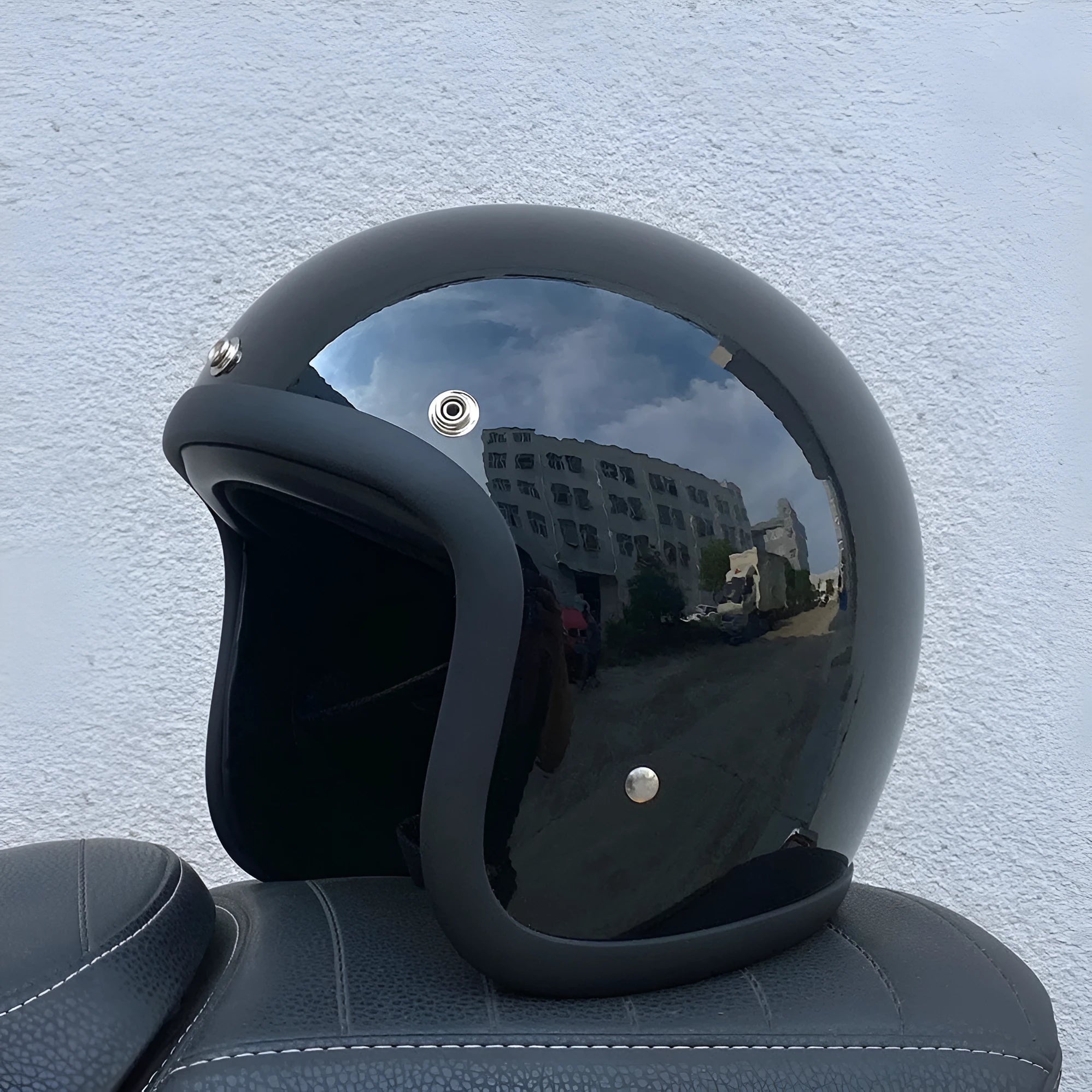 Glass fibre retro half motorcycle helmet shown in various colours including cement gray and matte black options