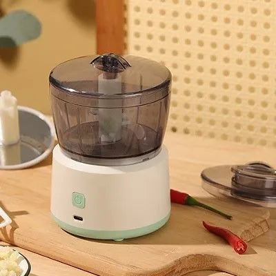 Mini electric meat grinder with transparent processing cup and stainless steel blades in white or light green