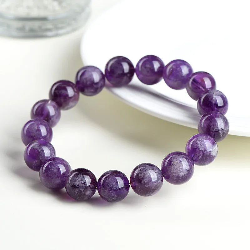 Natural feather amethyst crystal bracelet in snow mountain purple with scattered beads and ruyi geometry.