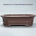 Purple clay handmade rectangular begonia flower pot on a desktop.