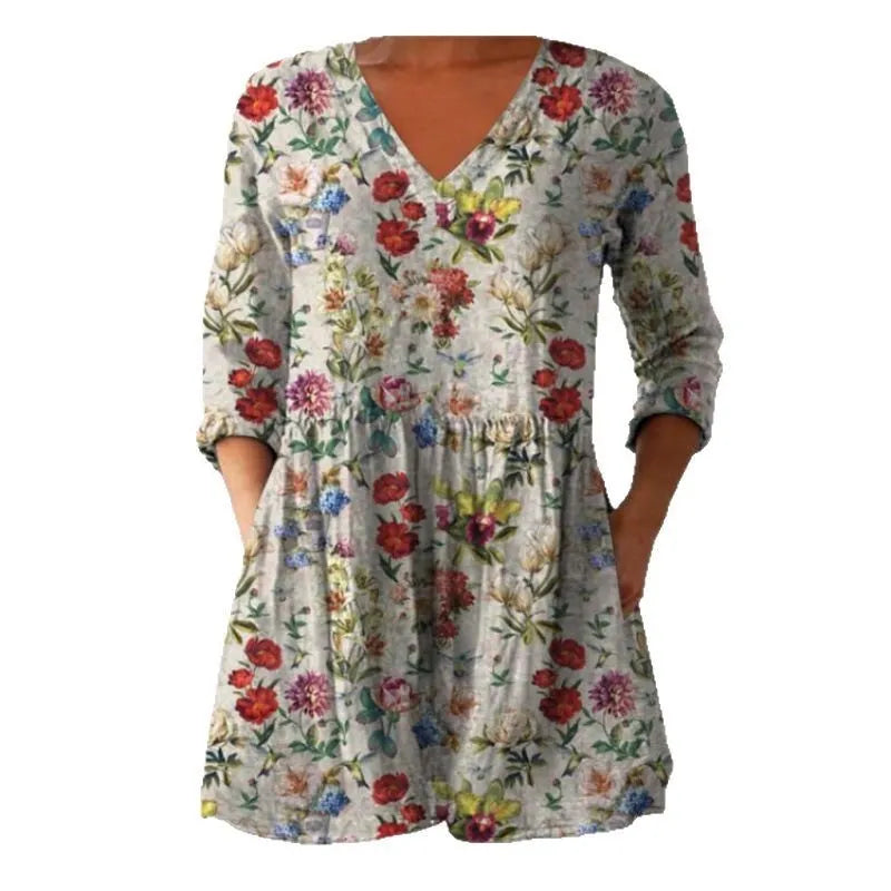 A woman wearing a loose, printed dress with 3/4 sleeves and a wide waist, available in multiple sizes.