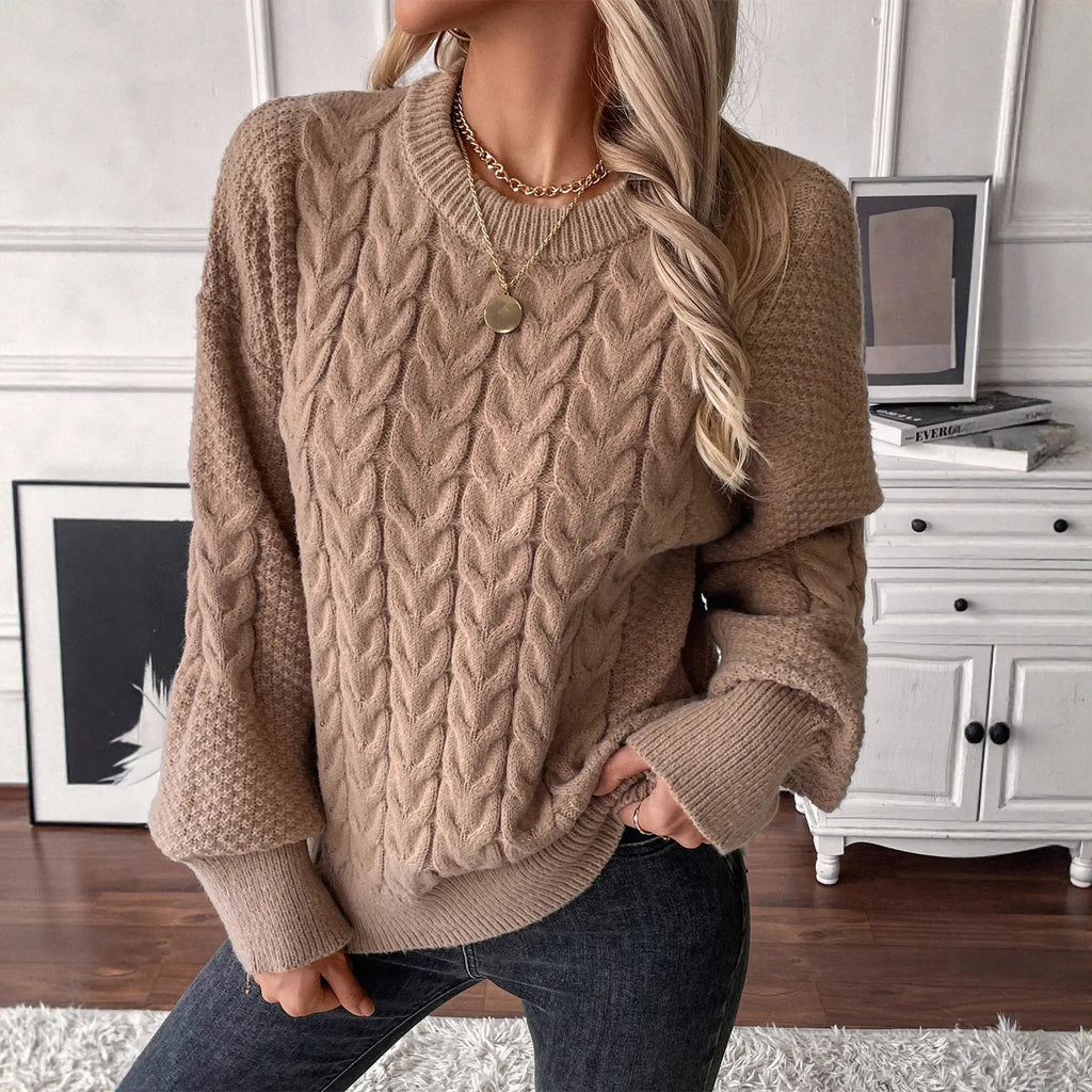 Beige women's loose round neck sweater with a twist design detail on the front.