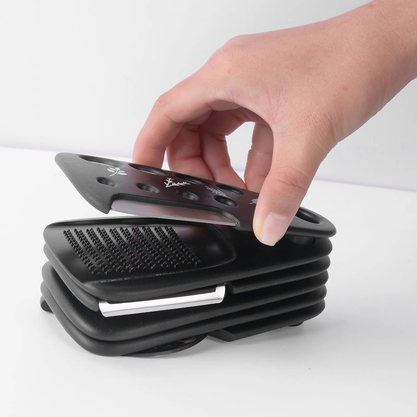 Six stackable kitchen gadget utensils and a cleaning brush in a colour box