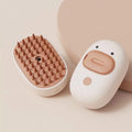 White and yellow pet steam brush grooming tool with rubber teeth and a water tank.