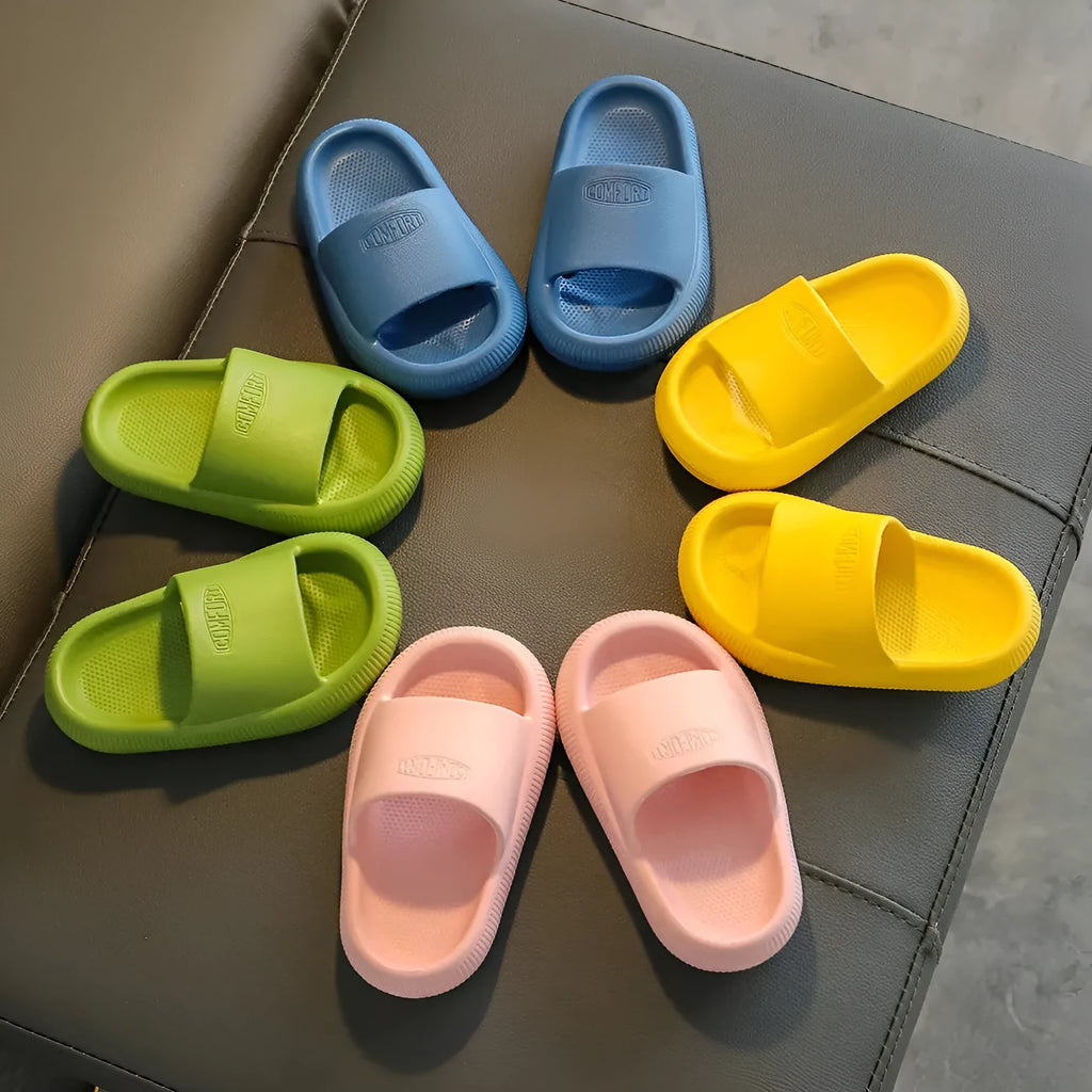 Children's EVA injection-moulded slippers with non-slip soles in mixed colours, shown in multiple sizes.