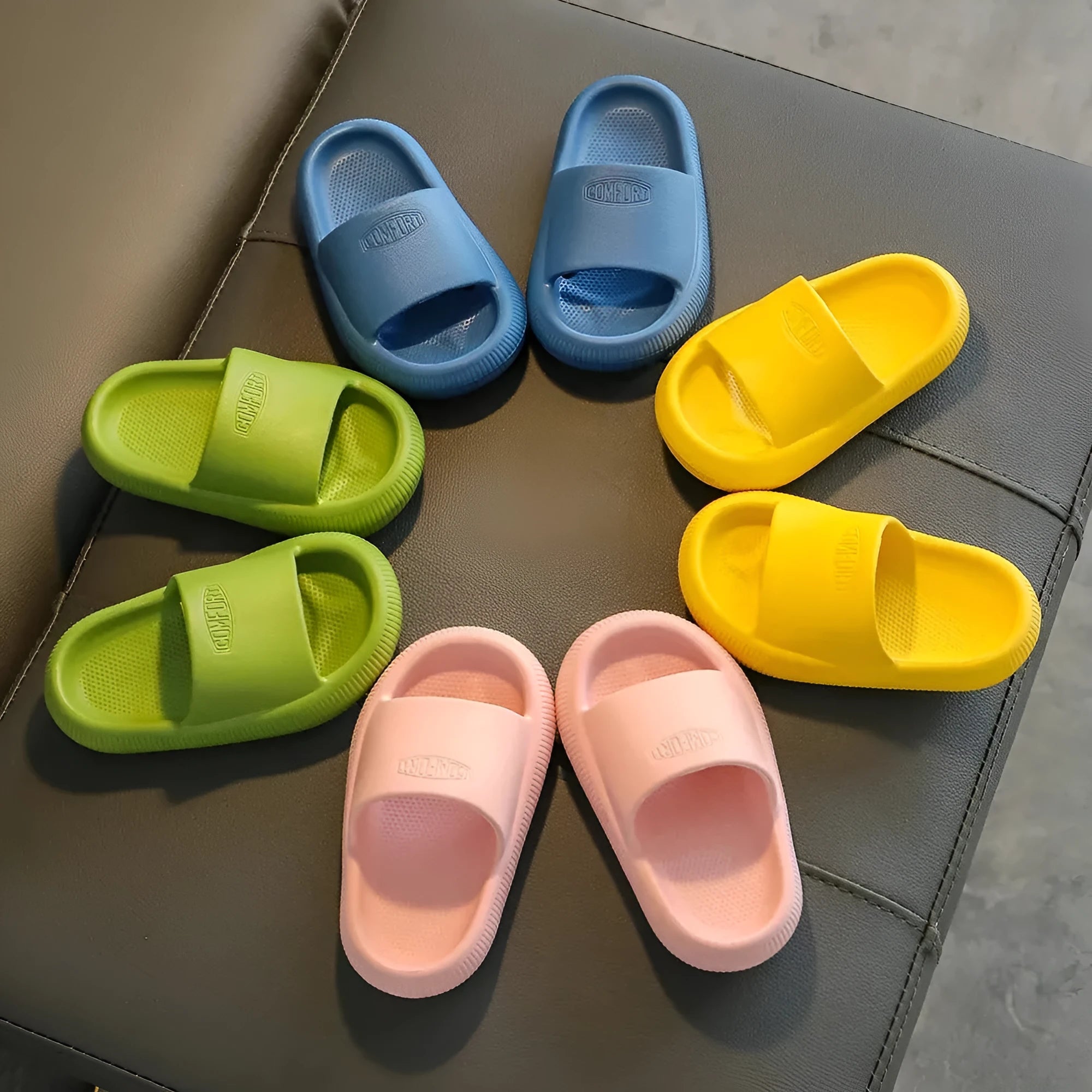 Children's EVA injection-moulded slippers with non-slip soles in mixed colours, shown in multiple sizes.