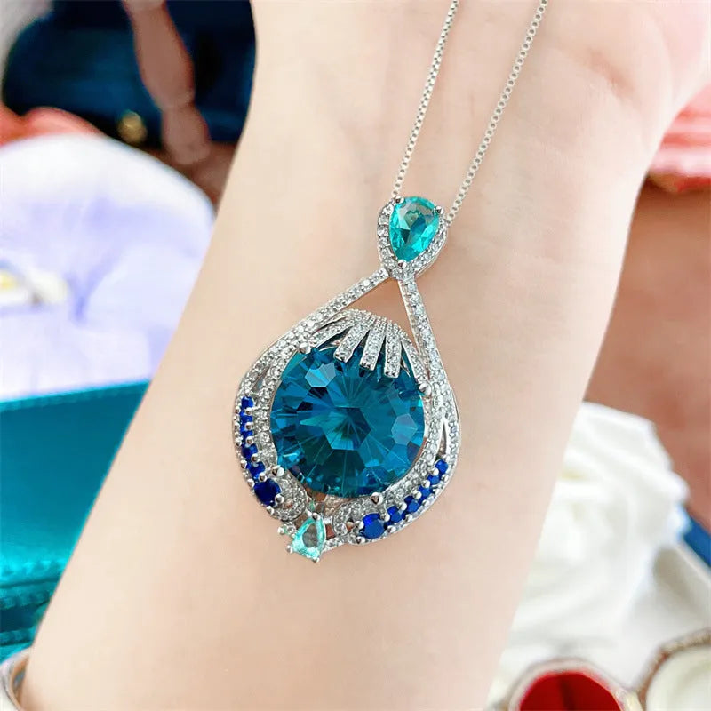 Blue geometric pendant necklace with fireworks cut gems and water wave chain