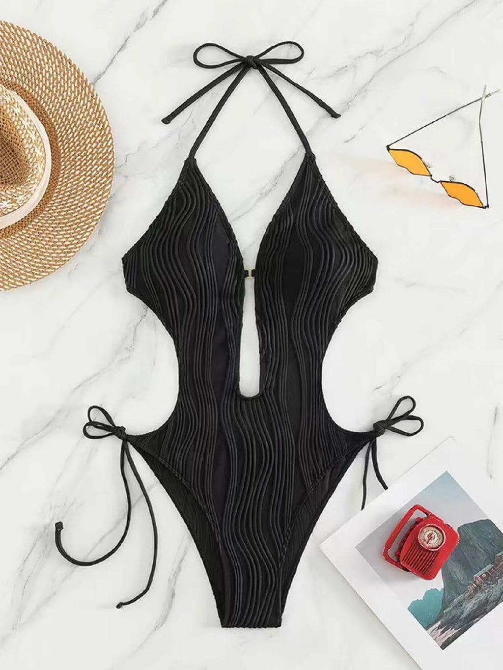 Women's black lace-up triangle bikini swimsuit on white background