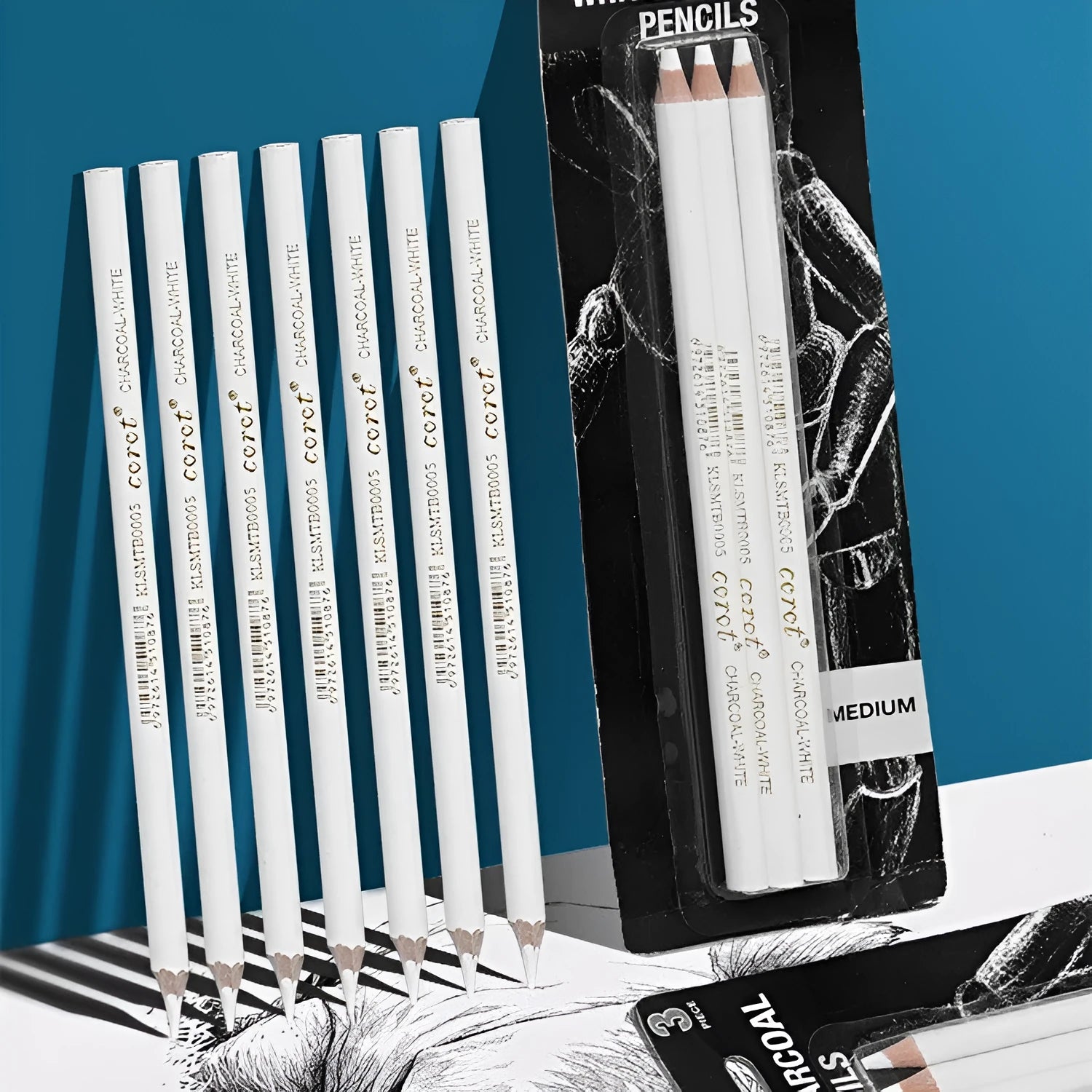 Set of three white charcoal pencils in wooden barrels for artistic highlighting