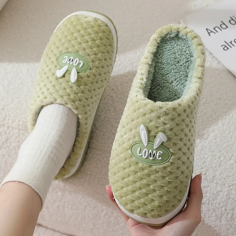 Women's rabbit and plaid print artificial fur slippers with thick rubber sole.