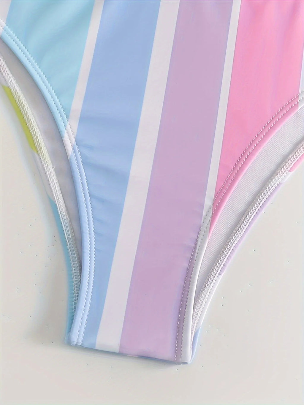 Women's striped sport bikini top and briefs on a white background.