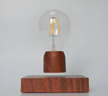 Magnetic levitation floating light bulb on imitation wood base with choice of international plugs.