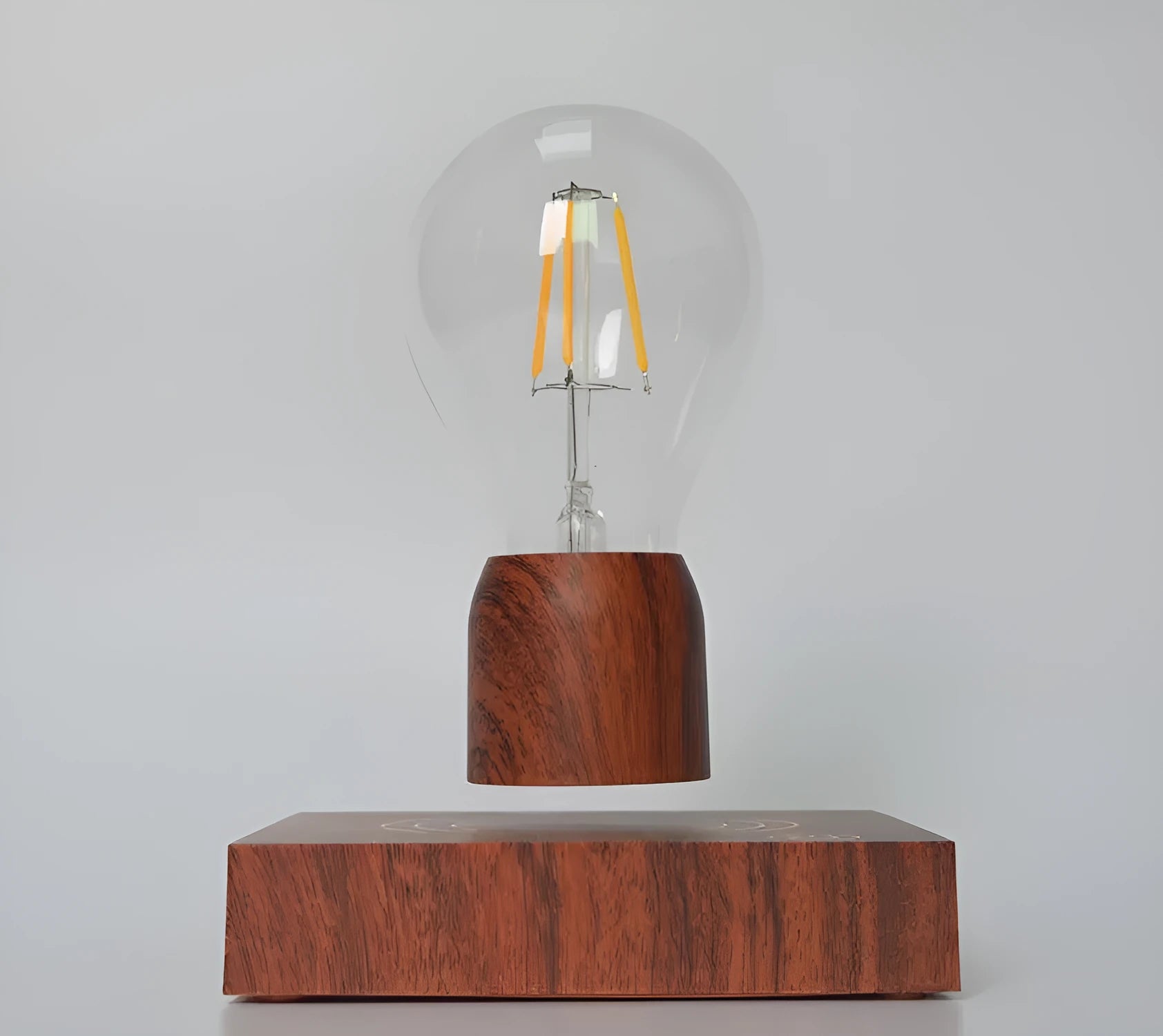 Magnetic levitation floating light bulb on imitation wood base with choice of international plugs.
