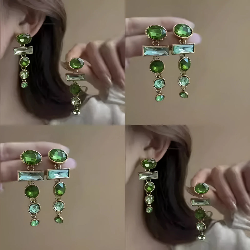 A pair of green gradient alloy earrings with geometric shapes, inlaid zircon stones, and decorative tassels.