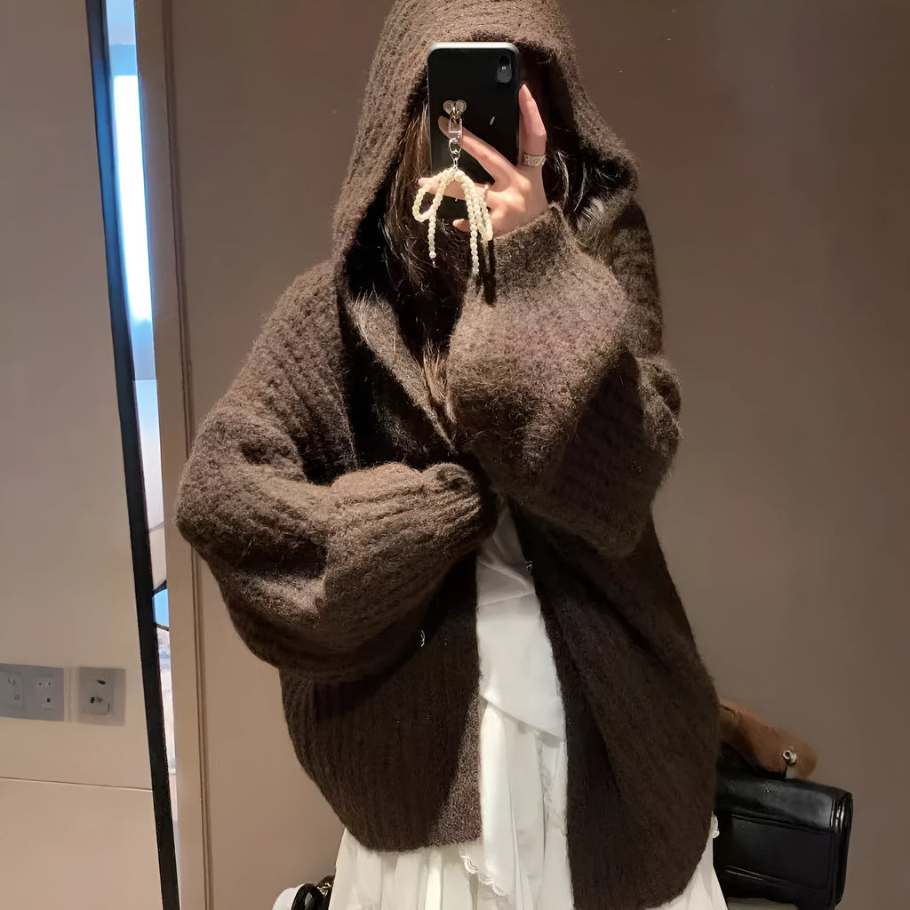 Woman wearing a brown retro-style Maillard hooded cardigan with a thick knit and loose fit.