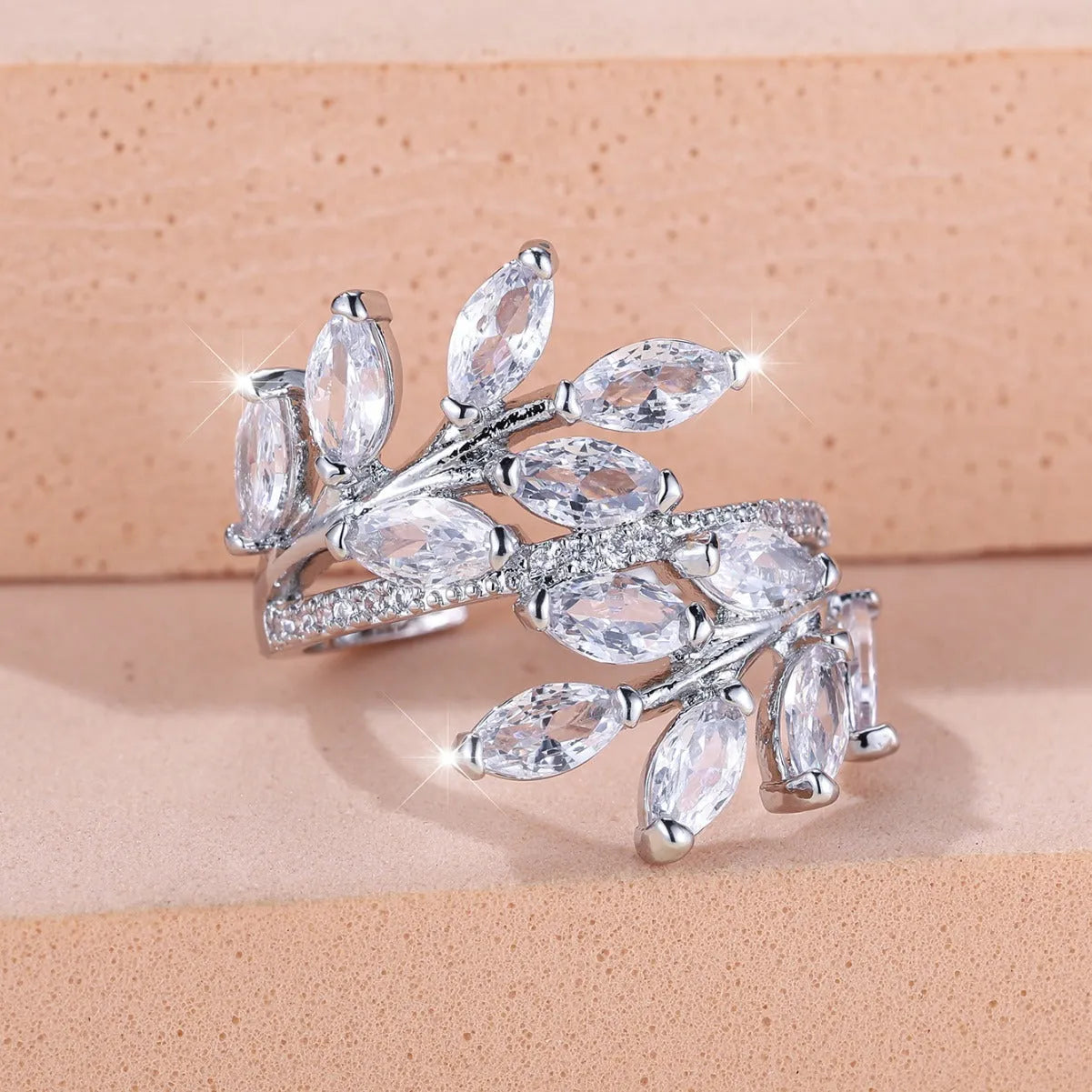 Adjustable horse eye design leaf ring in copper with zircon crystals, shown in a rose gold finish