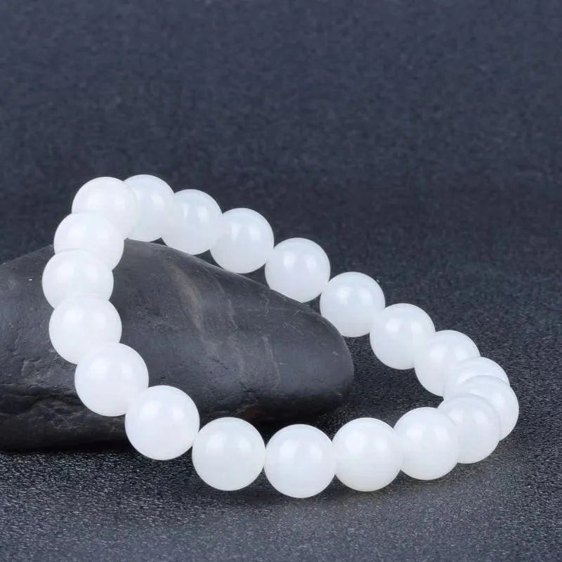 Hotan white jade goat fat round bead bracelet 10mm Hetian jade unisex national style on light background