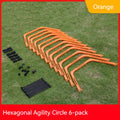 Set of six foldable yellow, green, and orange hexagon agility training rings on grass.