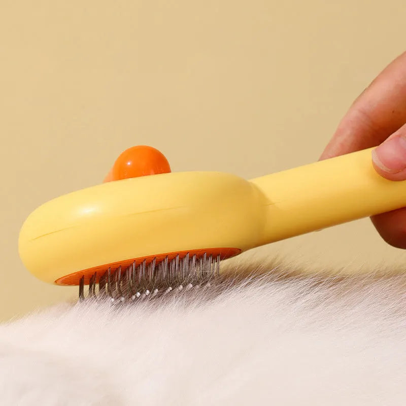 Small yellow duck comb for pet grooming with needle brush construction