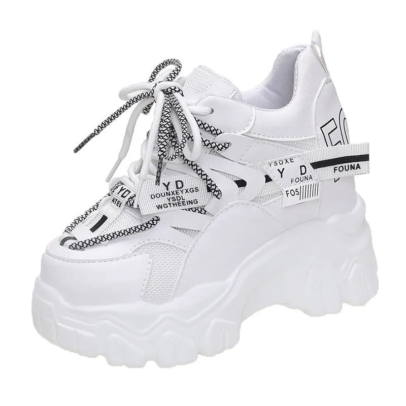 Women's white mesh platform sports shoes with cross strap and round toe on rubber sole.