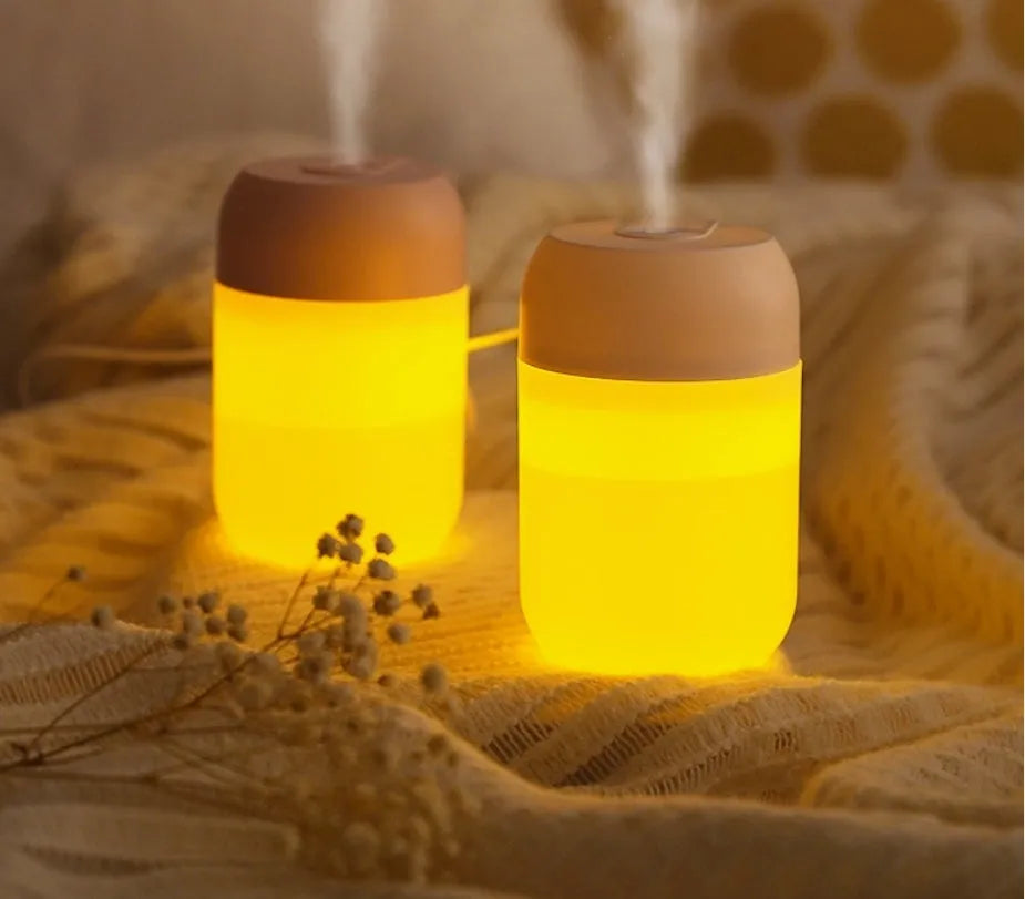 Small white cylindrical USB humidifier with aromatherapy function for desk use