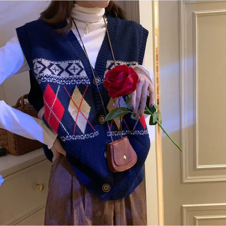 Woman wearing a khaki sleeveless cardigan with a diamond plaid pattern, loose fit.