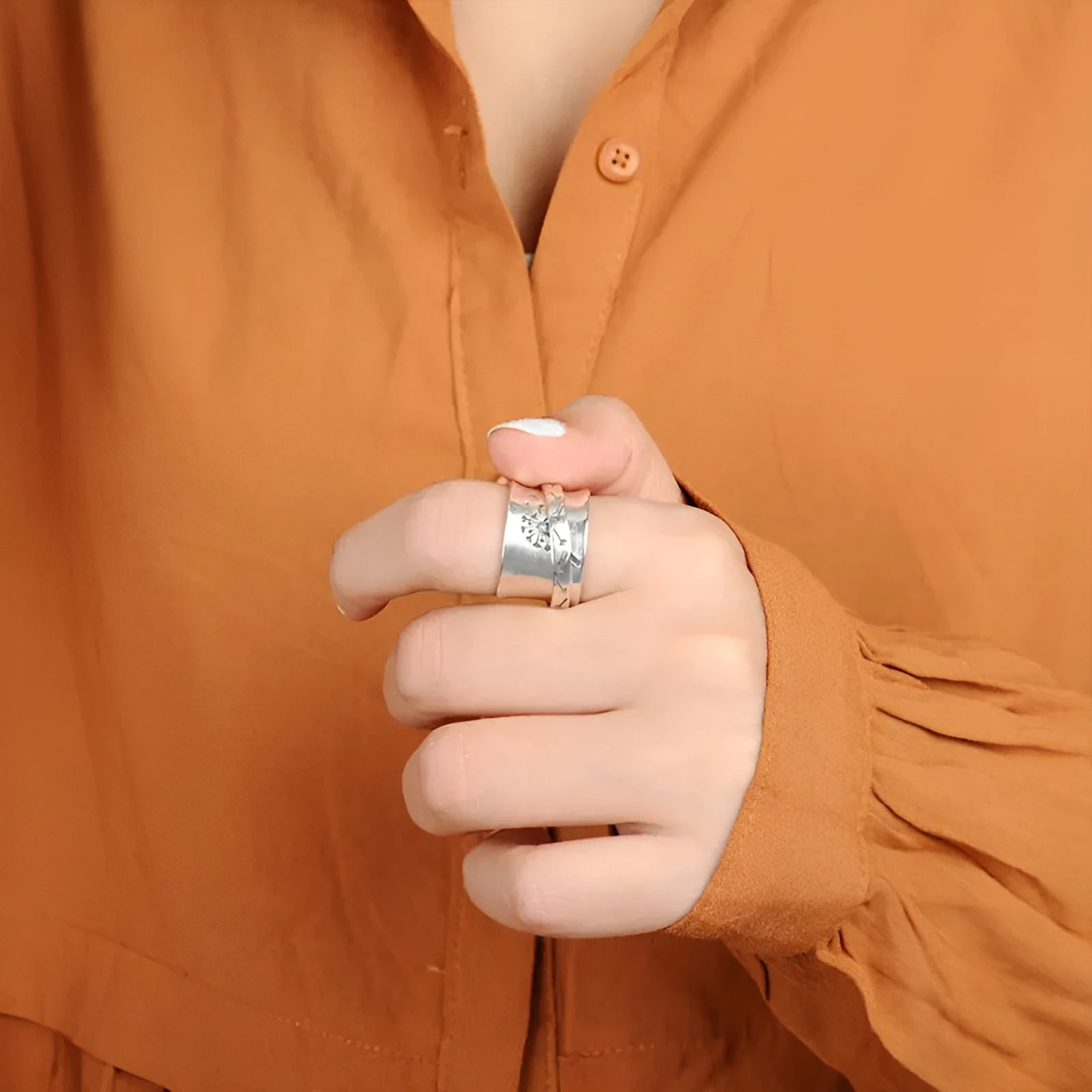 Silver rotatable flower ring showing floral design on alloy band