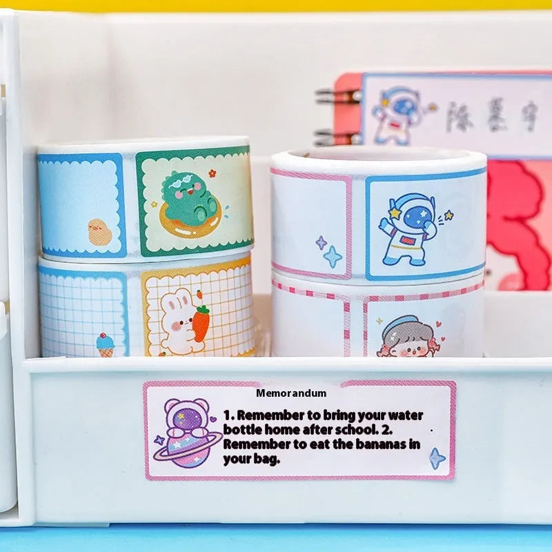 Roll of colourful cartoon name tape stickers with dinosaur, astronaut, rabbit, and girl designs.