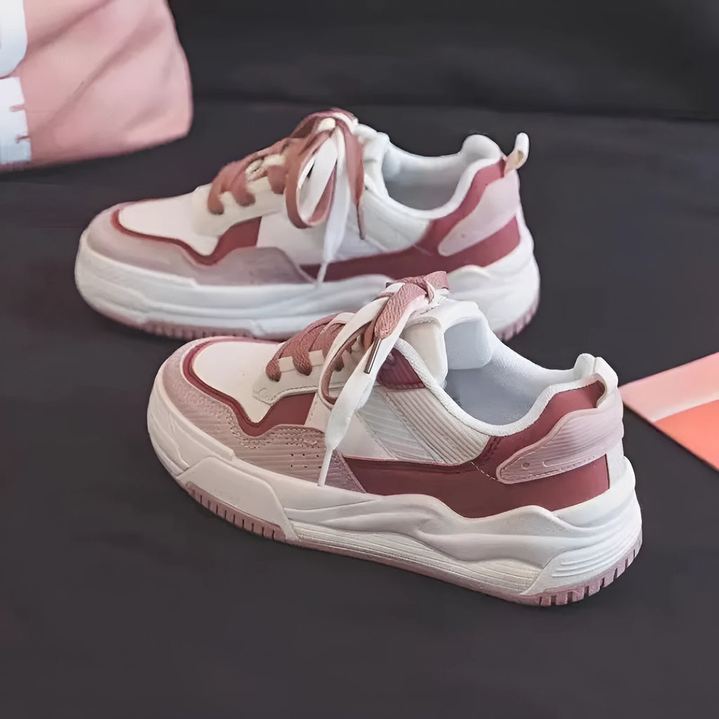 Women's pink low-top sneakers with imitation leather upper and rubber sole for hidden height increase.