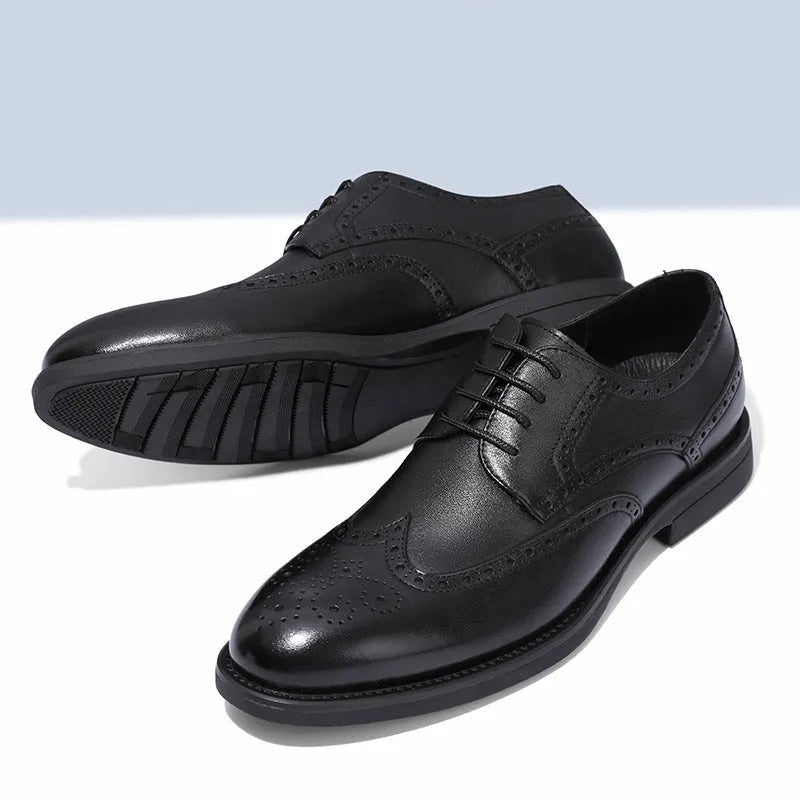 Men's black and brown brogue leather shoes for business style on a plain background.