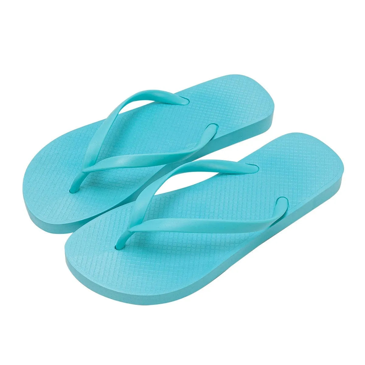 Orange foldable plastic beach slippers with a non-slip hollow-out PVC sole on a sandy background.