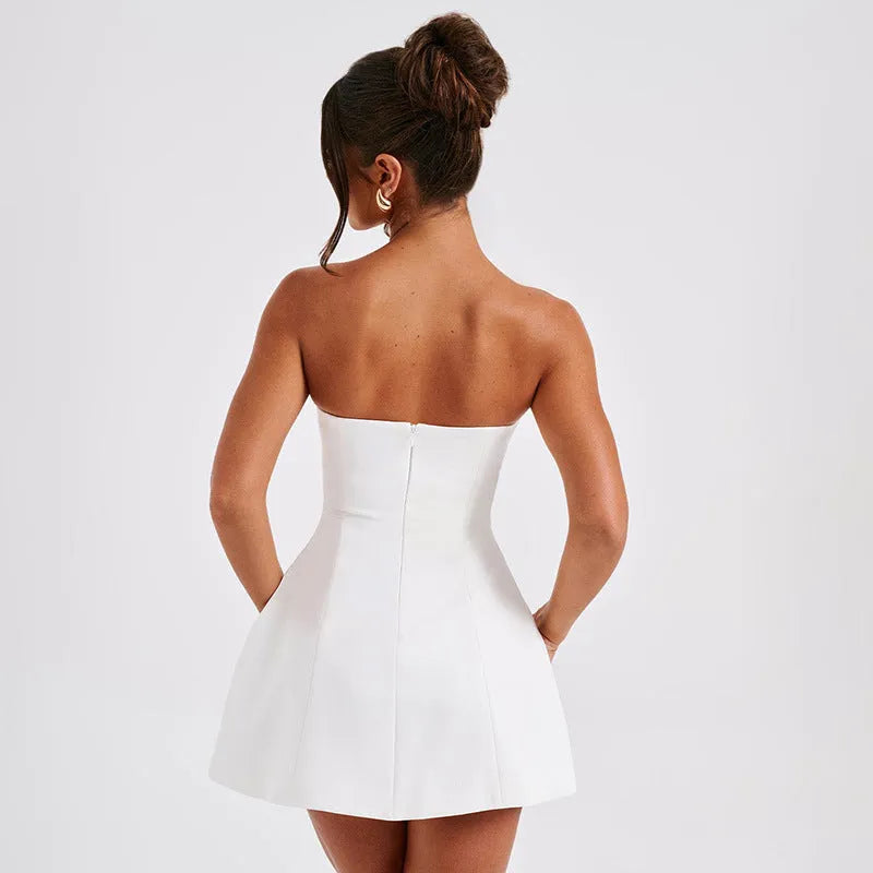 Women's solid colour backless tube dress with high waist and A-line skirt on a model.